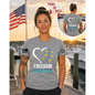 Nautical Salute Freedom Fighter District Perfect Tri Tee in Grey on marina sunset mockup for Nautical Salute