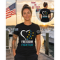 Nautical Salute Freedom Fighter District Perfect Tri Tee in Black on marina sunset mockup for Nautical Salute
