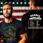Two men wearing t-shirts with 'Heroes in the Sky' and 'Green Star Families' designs in front of an American flag.